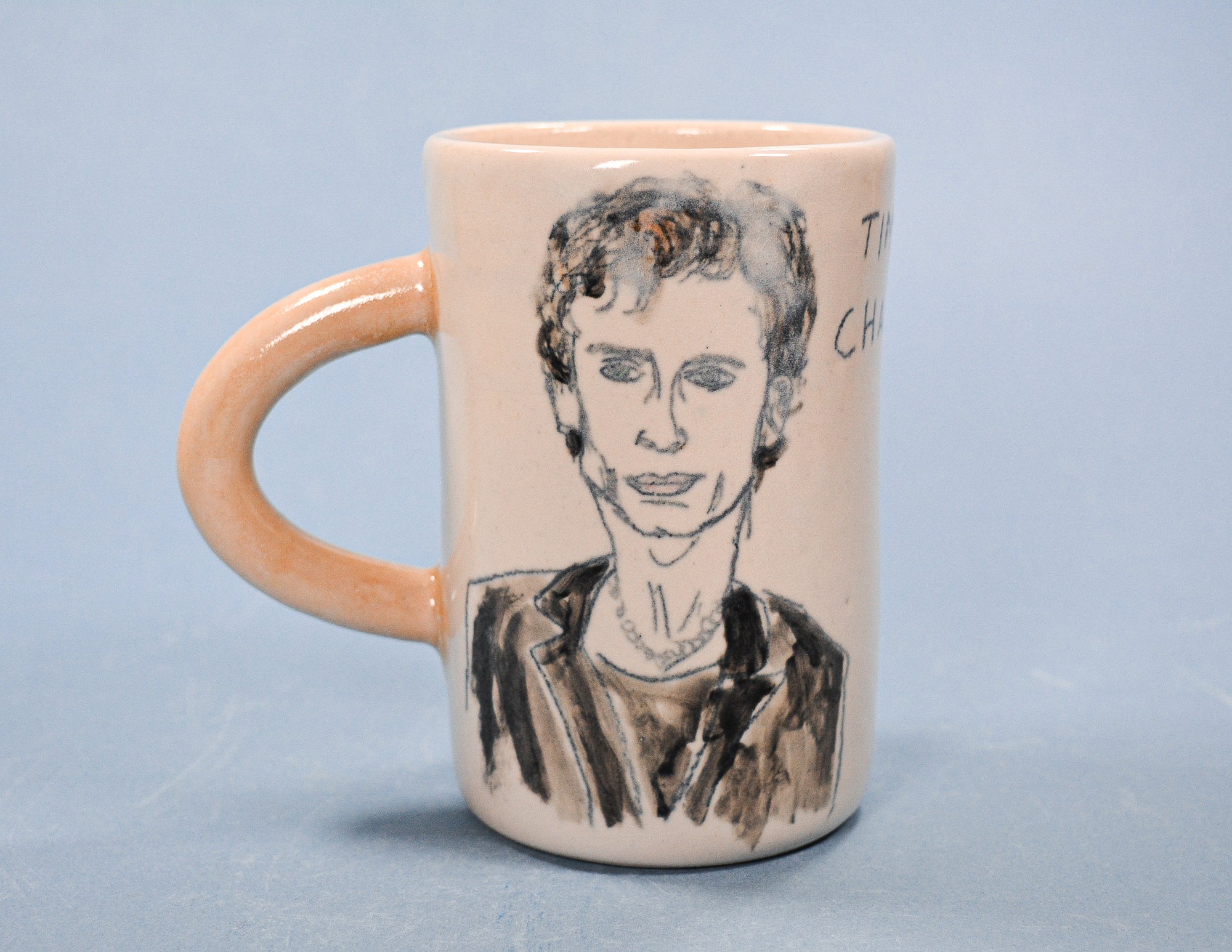 Mug with a portrait of Timothee Chalamet on a light blue background