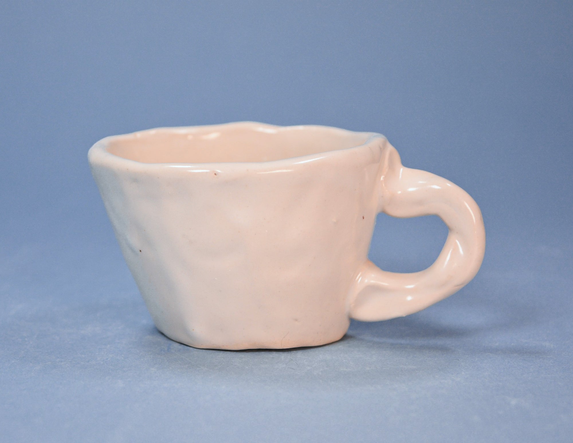 White ceramic mug on a blue background
