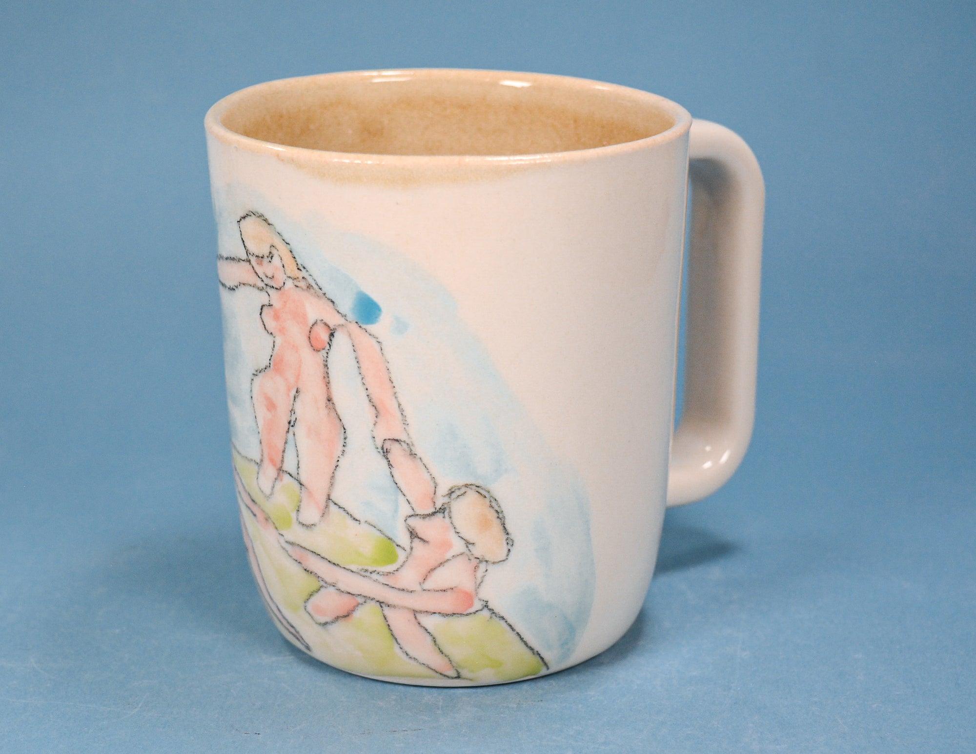 A white ceramic mug with a handle, featuring a hand-painted watercolor illustration of two figures in soft pink, blue, and green tones, set against a solid blue background.