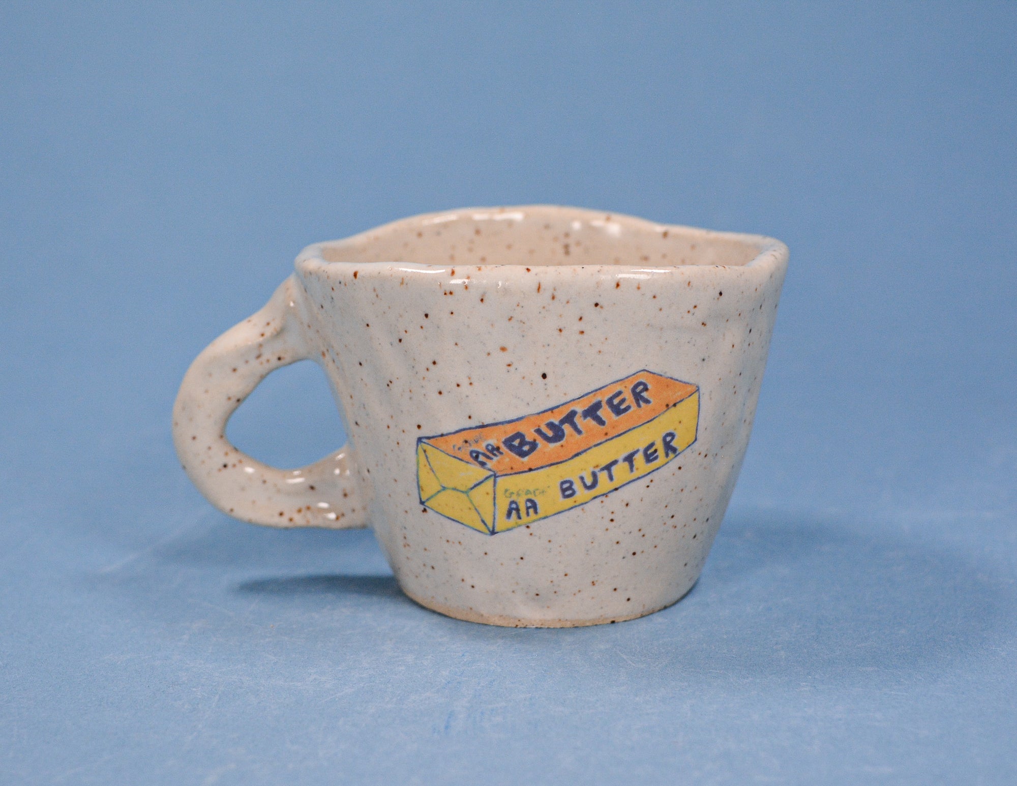 Handmade Butter Espresso Cup in cream-yellow glaze by Juice Ceramics, stoneware pottery espresso mug on neutral background